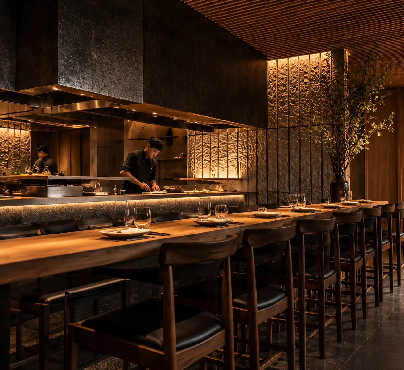 Warm architectural lighting over a beautifully set restaurant counter