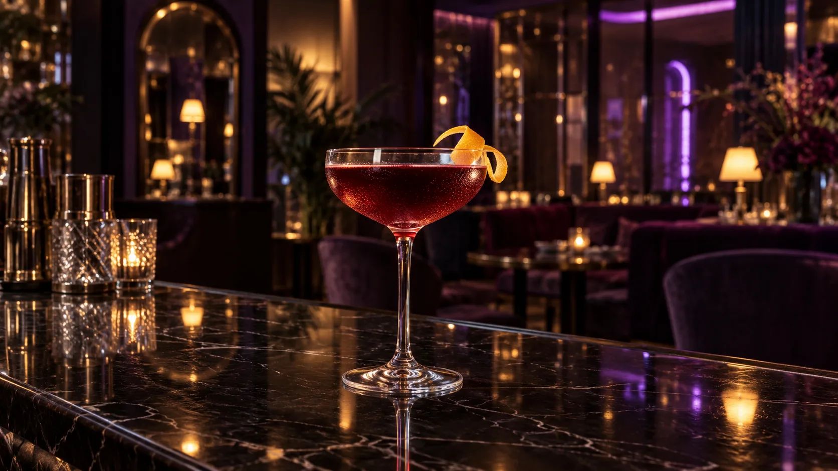 A ruby cocktail on a glossy bar with atmospheric violet light in the lounge behind